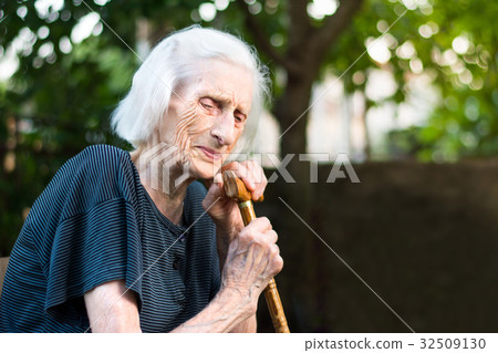 Senior woman crying with a walking cane 32509130