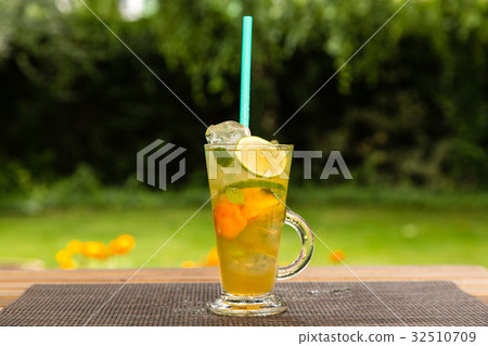 Homemade peach ice tea with lime and lemon balm 32510709