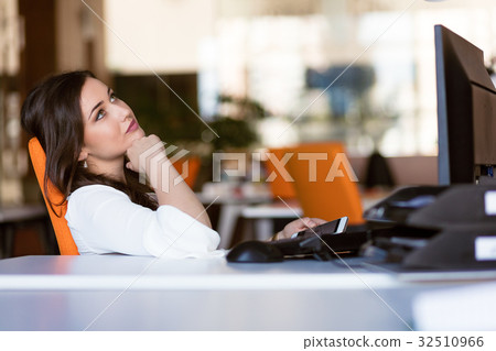 Happy pensive businesswoman planning and looking 32510966