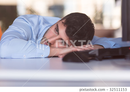 Portrait of a depressed office worker laying on 32511153