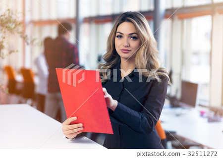 Team work discussing. Young woman with paper Team work discussing. Young woman with paper 32511272
