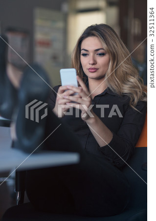 Typing business message. Confident young woman in Typing business message. Confident young woman in 32511364