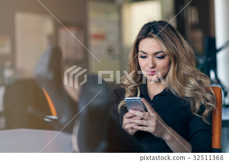 Typing business message. Confident young woman in Typing business message. Confident young woman in 32511368