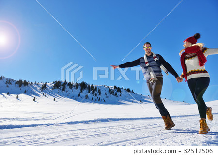 Cheerful young couple having fun in winter park Cheerful young couple having fun in winter park 32512506