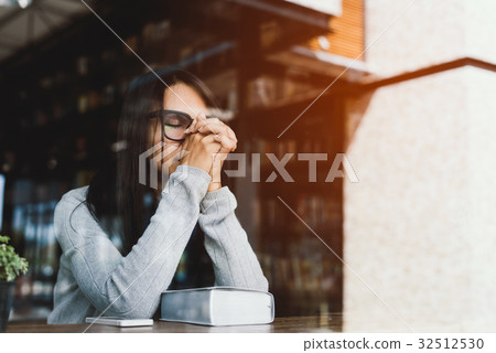 Girl reading the Bible in the library cafe. Girl reading the Bible in the library cafe. 32512530