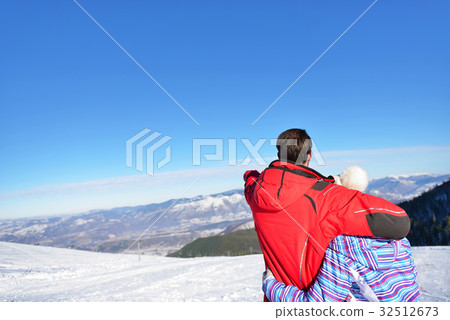 Rear view of a loving couple in fur hood jackets 32512673