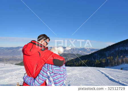 Rear view of a loving couple in fur hood jackets 32512729