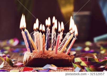 birthday cake with many lit candles birthday cake with many lit candles 32512857