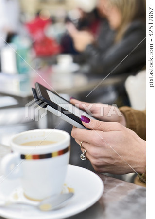 woman using a tablet in the terrace of a cafe woman using a tablet in the terrace of a cafe 32512867