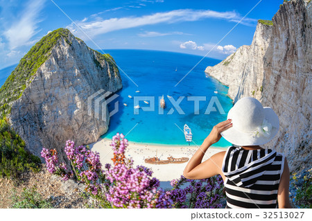 Woman on Navagio beach, Zakynthos island in Greece Woman on Navagio beach, Zakynthos island in Greece 32513027