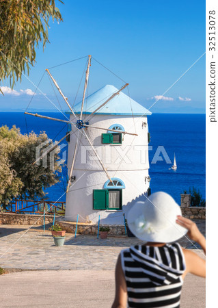 Woman against  windmill on Zakynthos in Greece 32513078