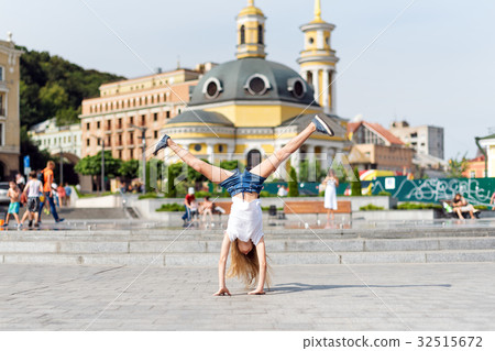 Active kid girl gymnast stretching and doing 32515672