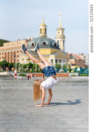 Active kid girl gymnast stretching and doing Active kid girl gymnast stretching and doing 32515683
