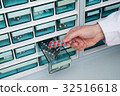 Pharmacist doctor who takes medicine from medicine shelf 32516618