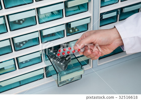 Pharmacist doctor who takes medicine from medicine shelf 32516618