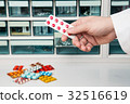 Pharmacist doctor who gives a lot of medicine from medicine shelf 32516619