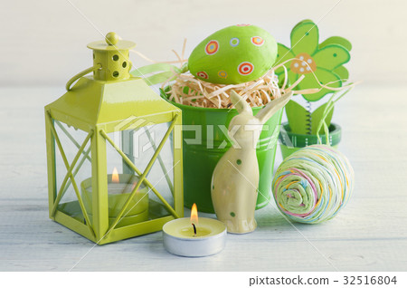 Green candle, toy rabbit, candle and eggs 32516804