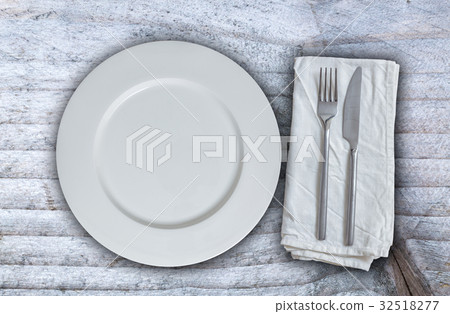 Empty plate with silverware on gray background Empty plate with silverware on gray background 32518277