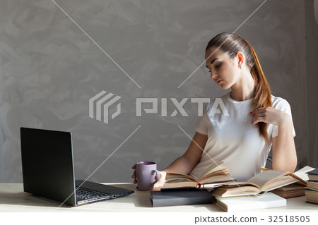 girl reading a book and drinking coffee 32518505