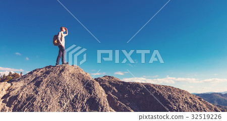 Man walking on the edge of a cliff 32519226