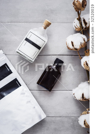 Coconut oil, woman body coffee scrub on gray Coconut oil, woman body coffee scrub on gray 32520019