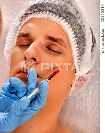 Dermal fillers of man in spa salon with beautician Dermal fillers of man in spa salon with beautician 32520310