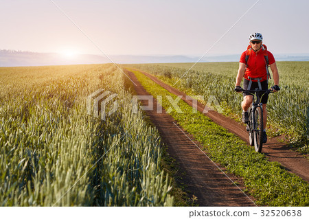 Young cyclist with mountain bicyclist on the path Young cyclist with mountain bicyclist on the path 32520638