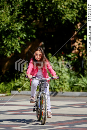 Cute kid girl in blue helmet going to ride her Cute kid girl in blue helmet going to ride her 32521167