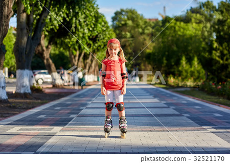 Girl riding on roller skates in skatepark summer Girl riding on roller skates in skatepark summer 32521170
