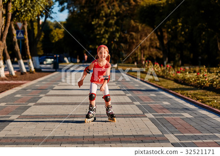 Girl riding on roller skates in skatepark summer Girl riding on roller skates in skatepark summer 32521171