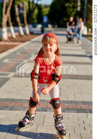 Girl riding on roller skates in skatepark summer Girl riding on roller skates in skatepark summer 32521173