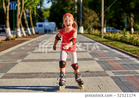 Girl riding on roller skates in skatepark summer Girl riding on roller skates in skatepark summer 32521174