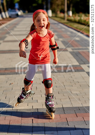 Girl riding on roller skates in skatepark summer Girl riding on roller skates in skatepark summer 32521175