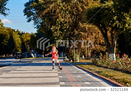 Girl riding on roller skates in skatepark summer Girl riding on roller skates in skatepark summer 32521189
