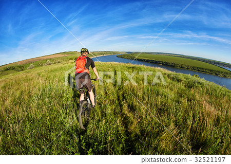 Active bicyclist at the riverside 32521197