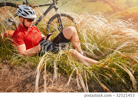 Biker in red t-shirt white helmet with backpack Biker in red t-shirt white helmet with backpack 32521453