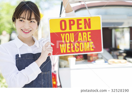A woman with a kitchen car open sign 32528190
