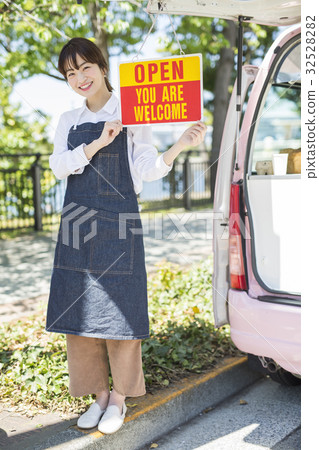 A woman with a kitchen car open sign 32528282