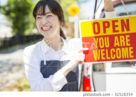 A woman with a kitchen car open sign 32528354