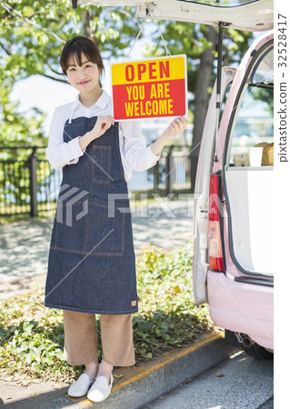 A woman with a kitchen car open sign 32528417