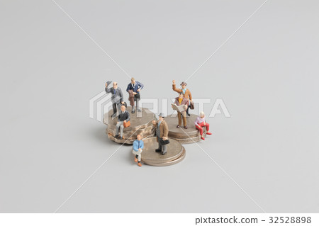 Business man on the top of coins stack Business man on the top of coins stack 32528898