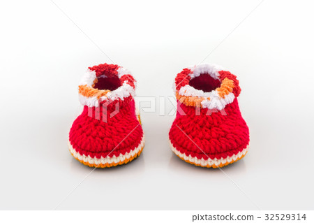 Little baby shoes. Kids knitted shoe handicraft. 32529314