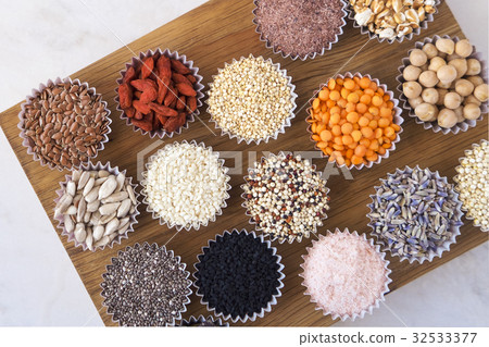 Various superfoods on white table Various superfoods on white table 32533377