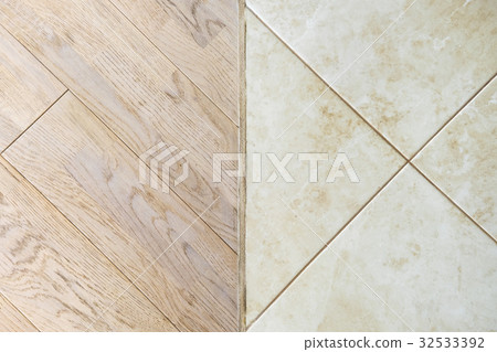 Wooden laminate floor and marble tile 32533392