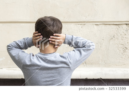 Young kid with closed ears 32533399