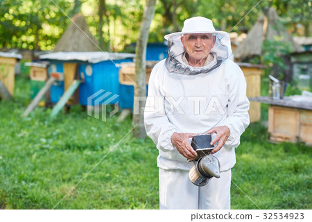 Senior beekeeper working at his apiary 32534923
