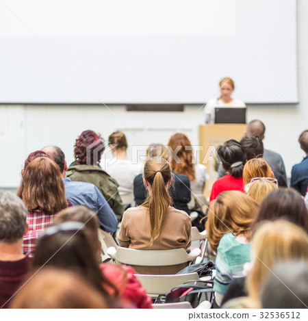 Woman giving presentation in lecture hall at 32536512