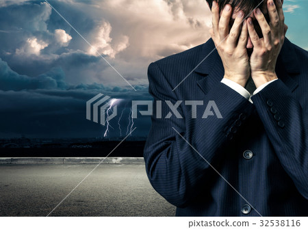 Businessman in despair on stormy sky Businessman in despair on stormy sky 32538116