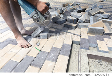 Worker cuts paving slabs for laying on the terrace 32539714