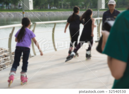 Blurred young people playing roller skates outdoor 32540530